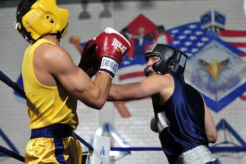 Two boxers fighting in a boxing ring.