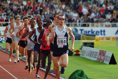 A line of runners, one behind the other, competing in a race.