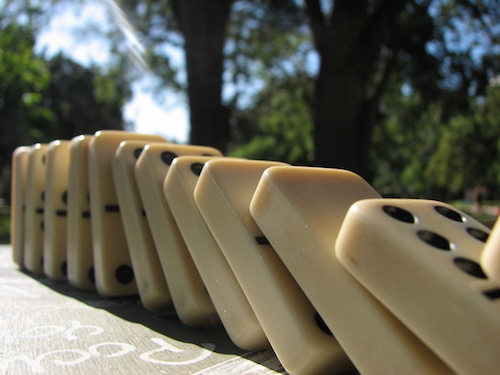 a line of dominoes starting to fall