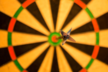 A dartboard with a single dart in the bullseye